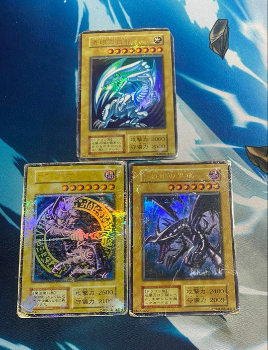 Yugioh Blue-Eyes White Dragon, Red-Eyes Black Dragon, Black Magician cards in used condition stored in desiccant box