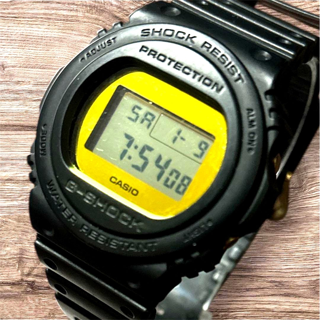 Casio G-Shock DW-5700BBMB-1JF digital watch with black resin band and gold metallic mirror face