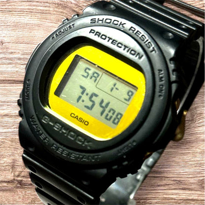 Casio G-Shock DW-5700BBMB-1JF digital watch with black resin band and gold metallic mirror face