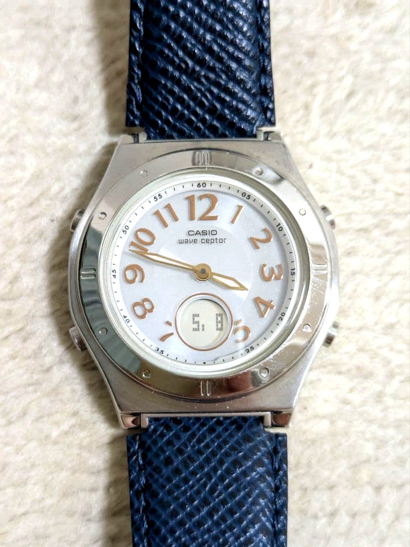 Casio Wave Ceptor watch with white dial, stainless steel case, synthetic leather strap, and tough solar function