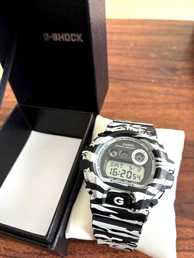 Casio G-Shock digital watch with green camouflage pattern on band and face
