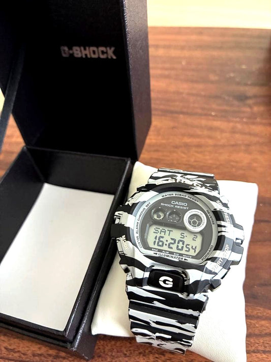 Casio G-Shock digital watch with green camouflage pattern on band and face