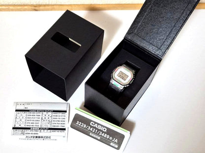 Casio G-Shock GM-S5640GEM-7JR watch with metal bezel and multicolor resin band shown on white background