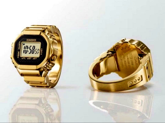 Casio G-Shock CRW-001G-9JR gold ring watch with original box, warranty card, and booklet