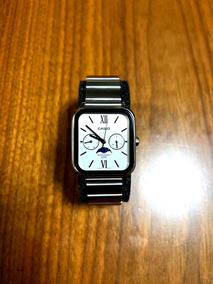 Casio MTP-M305D-7A2 silver stainless steel watch with moon phase and date display on white background
