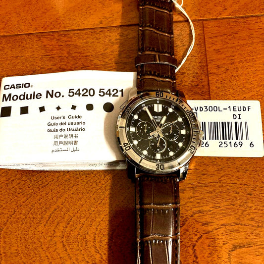 Casio International Model wristwatch with black dial, stainless steel band, day and date display