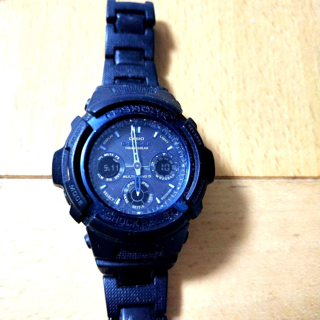 Casio G-Shock black wristwatch with resin band and stainless steel back case showing Tough Solar power features