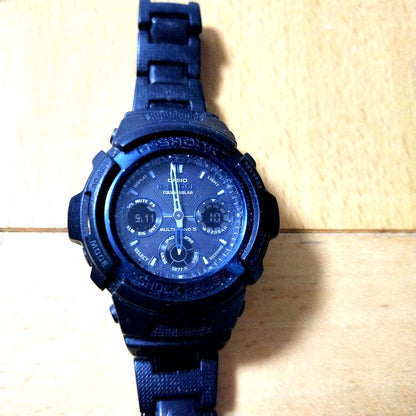 Casio G-Shock black wristwatch with resin band and stainless steel back case showing Tough Solar power features