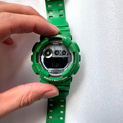 Casio G-Shock GD120TS digital watch in green with a durable, scratch-free display
