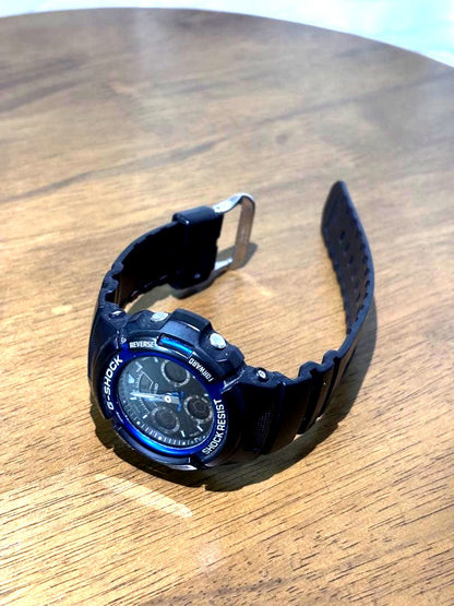 Casio G-Shock black and blue wristwatch showing dial and strap