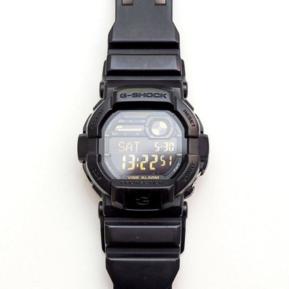 Casio G-Shock GD-350 wristwatch with black case and band, showing LCD screen and minor wear