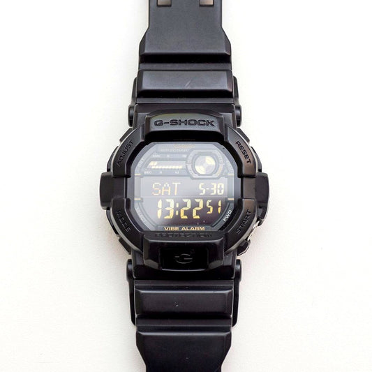 Casio G-Shock GD-350 wristwatch with black case and band, showing LCD screen and minor wear