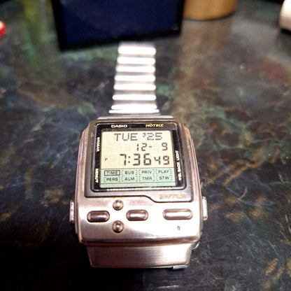 Casio DB-2000 digital wristwatch showing time on digital display with alarm and stopwatch functions