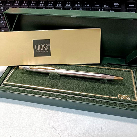 Cross Classic Century silver and gold metal ballpoint pen with case on white background