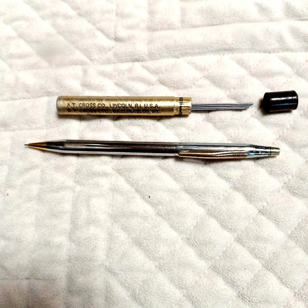 A.T. Cross silver and gold ballpoint pen made in USA shown with replacement refill