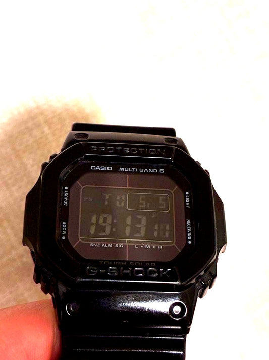 Casio G-Shock GW-M5610BB black radio solar watch showing digital display and rugged design