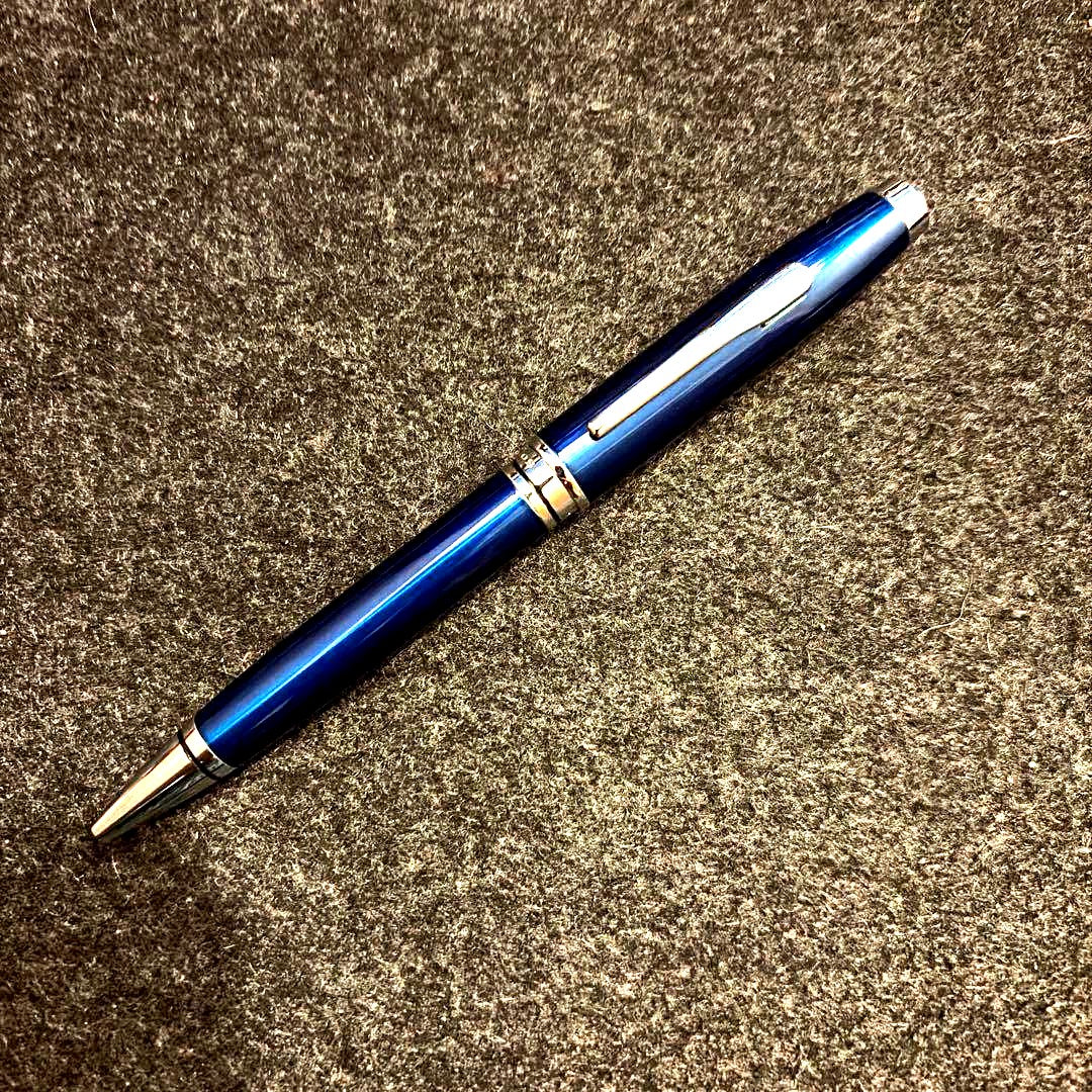 Cross twist ballpoint pen in navy with silver trim shown against white background