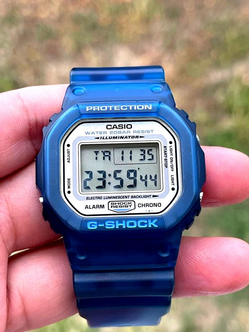 Casio G-Shock DW-5600 blue wristwatch with digital display and blue band