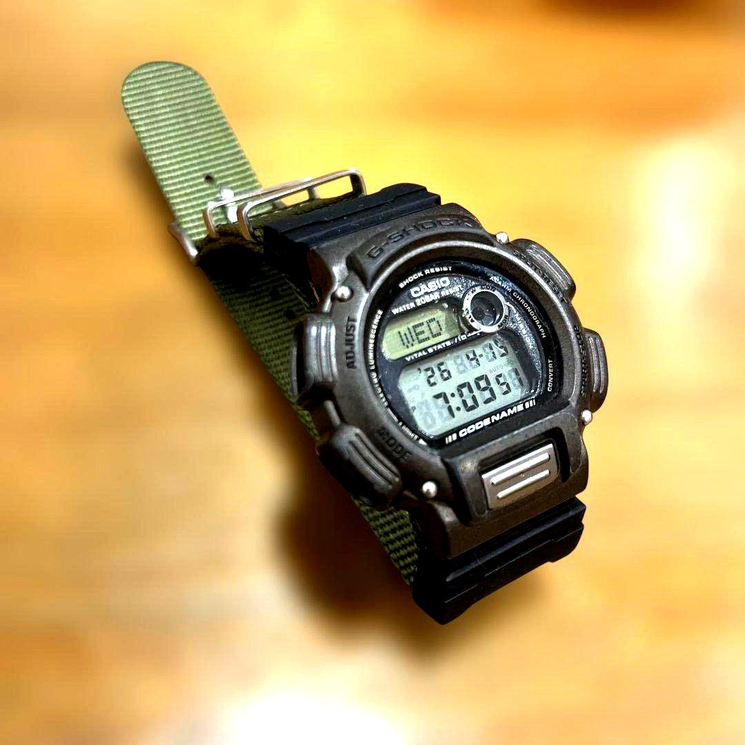 Casio G-Shock DW-8800 men's watch from 1990s with black replaced band and visible scratches on display