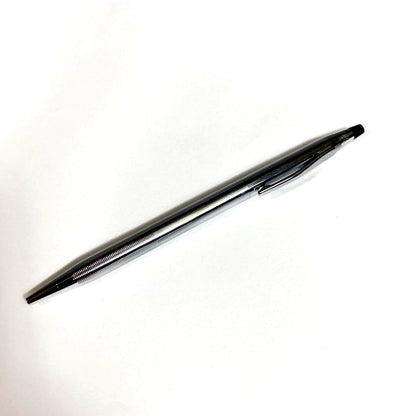 Used Cross brand silver ballpoint pen with blue ink shown on a white background