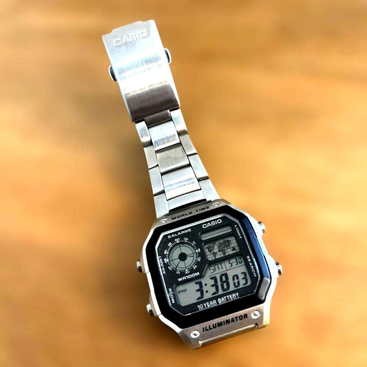 Casio World Time Series digital watch with silver stainless steel band showing time and world time features