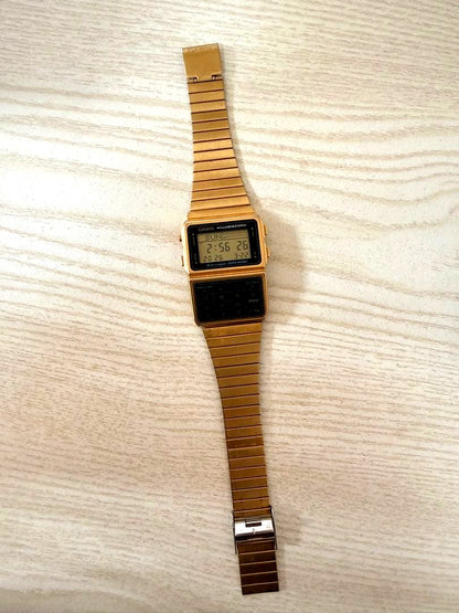 Casio Data Bank DBC-611G digital watch in gold color showing front view with clear display