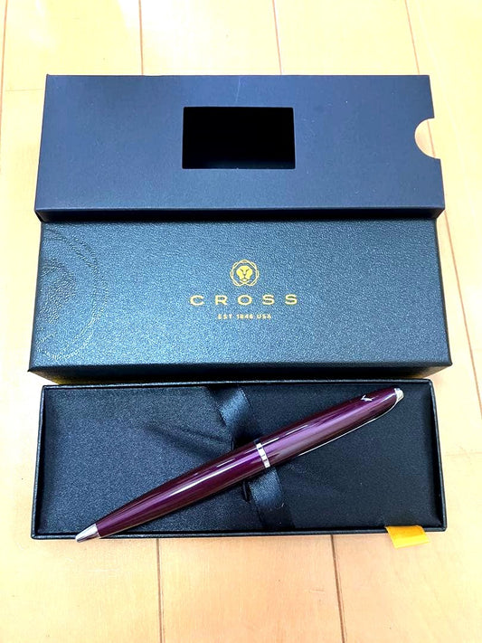 Cross burgundy fountain pen beside its dedicated protective case on a white background