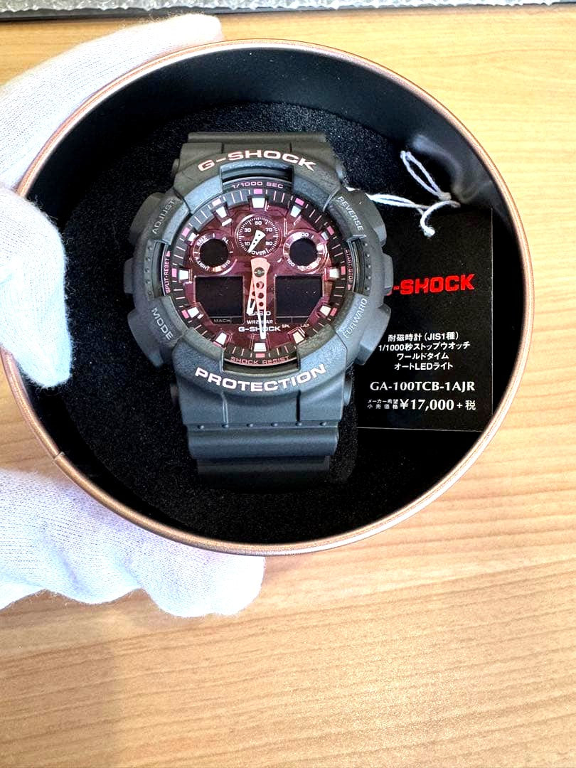 Casio G-Shock GA-100TCB-1AJR black and yellow analog-digital watch with tags and inner box