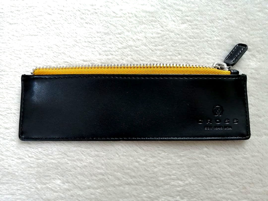 Cross brand leather pen case in used condition with visible scratches and stains