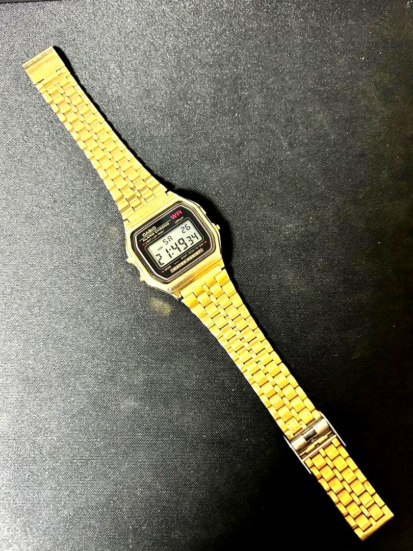 Casio A159W digital wristwatch with gold finish showing time and date on display