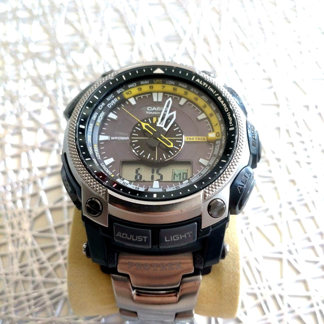 Casio Pro Trek PRW-5000T-7JF titanium watch with yellow and black dial showing analog and digital displays