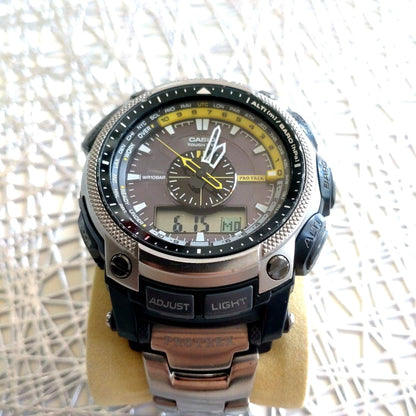 Casio Pro Trek PRW-5000T-7JF titanium watch with yellow and black dial showing analog and digital displays