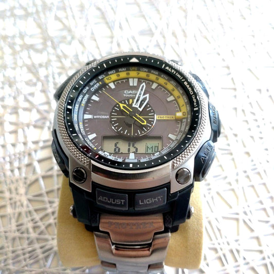Casio Pro Trek PRW-5000T-7JF titanium watch with yellow and black dial showing analog and digital displays