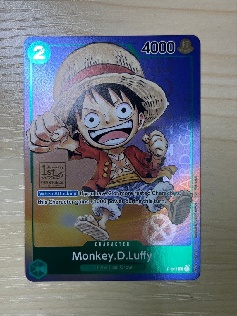 One Piece Monster D. Luffy 1st Anniversary Promo English version card with visible surface wear and white fade on the back