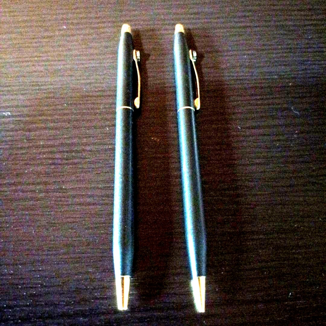 Cross twist ballpoint pen and mechanical pencil set in matte black with gold accents and shell logo