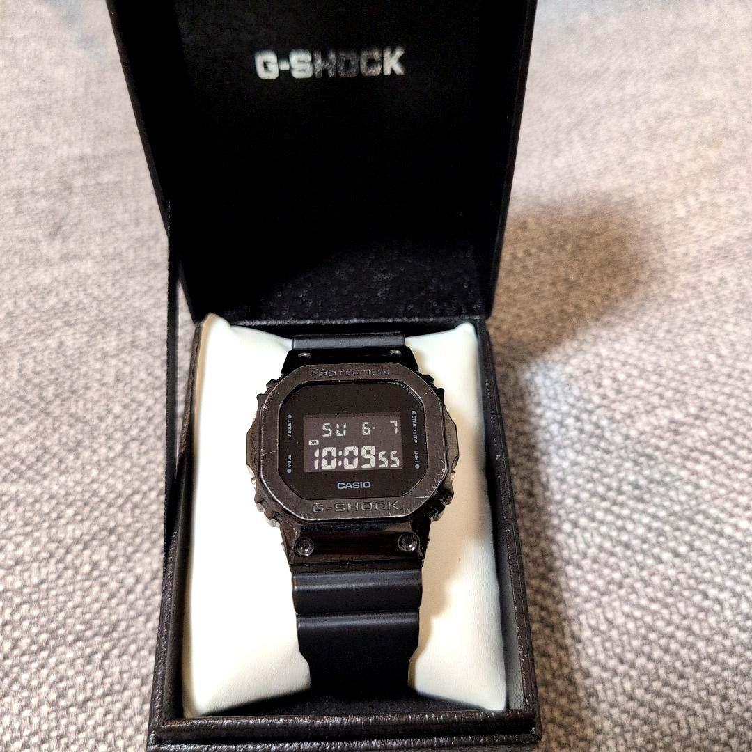 Casio G-Shock GM-5600B-1JF watch with octagon dial and black resin band showing minor metal scratches