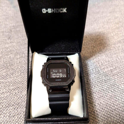 Casio G-Shock GM-5600B-1JF watch with octagon dial and black resin band showing minor metal scratches