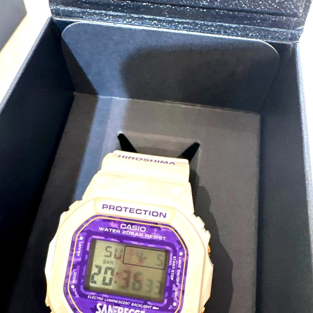 Casio G-Shock watch collaboration with Sanfrecce Hiroshima featuring white and purple colors and branded dial and band.