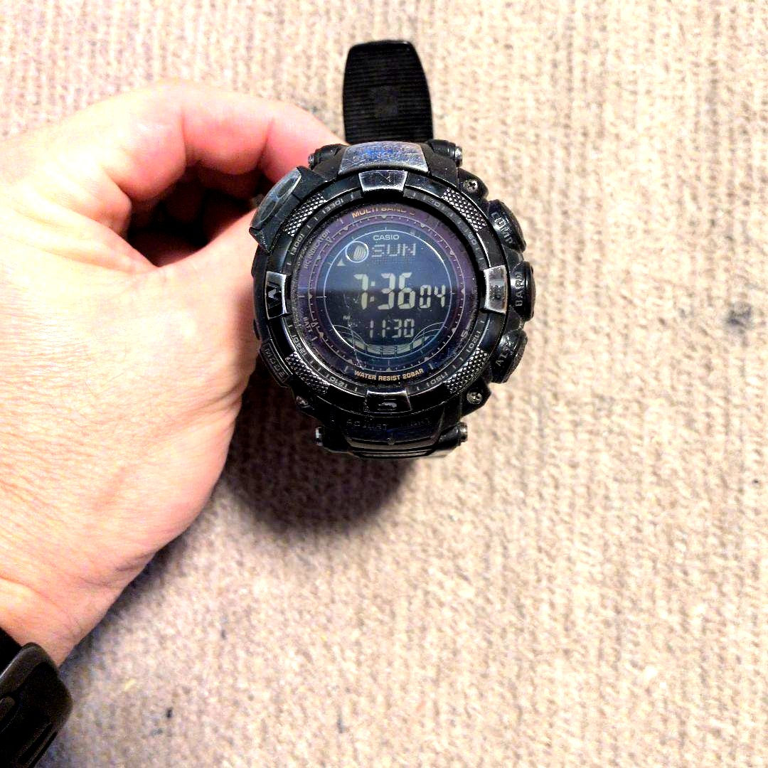 Casio Pro Trek PRW-1500YJ digital watch with compass, solar power, radio control, visible display scratches, and dirt on band