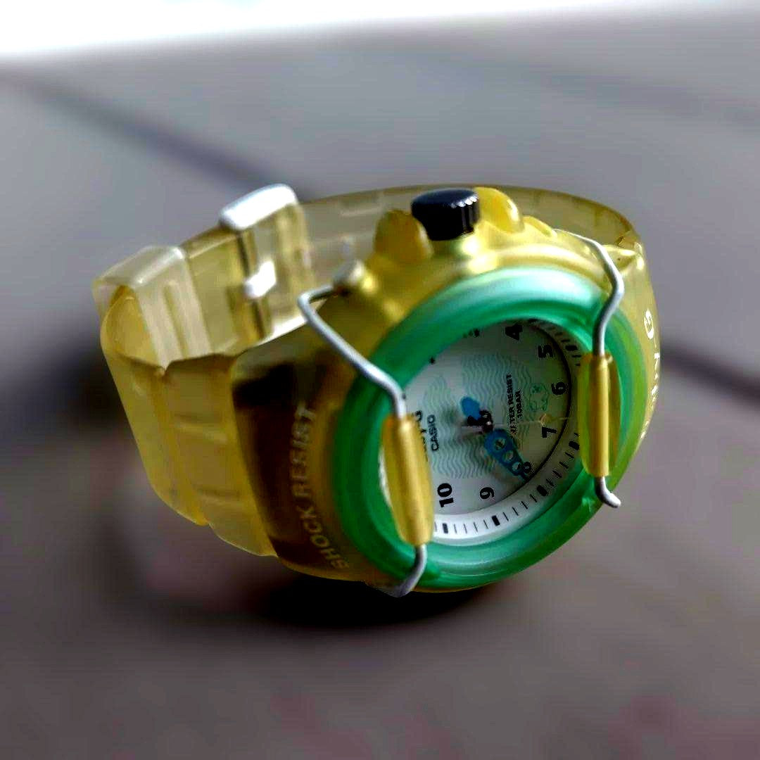 Casio Baby-G analog wristwatch with transparent green and yellow design and waterproof feature