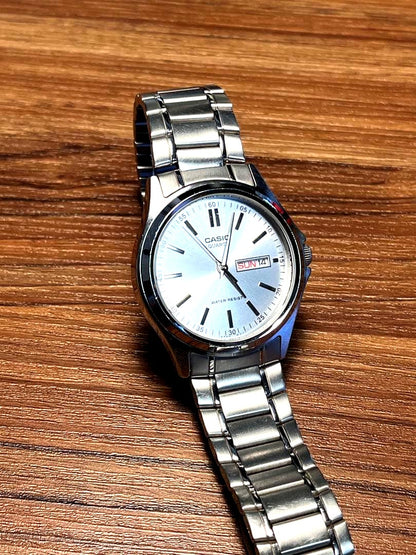 Casio MTP-1239DJ quartz watch with silver sunray dial, day and date display, and stainless steel case