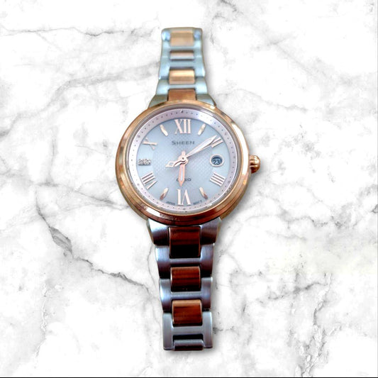 Casio Sheen ladies analog watch with silver and rose gold finish, solar powered, sapphire glass, and date display