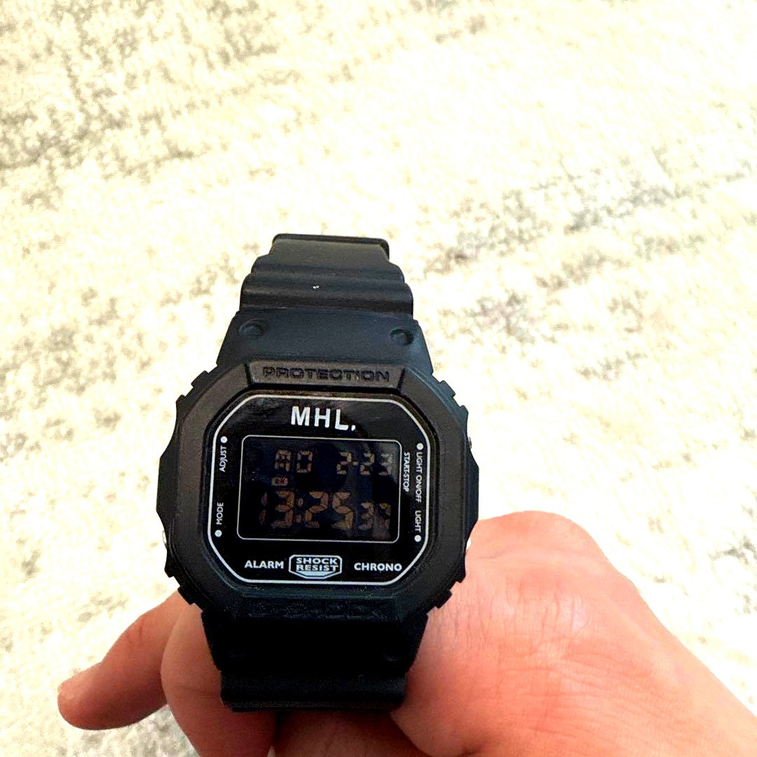 Casio MHL Digital Watch black model showing front face with digital display and black strap