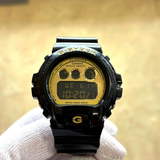 Casio G-Shock DW-6900CB black and gold wristwatch showing face and band Japan import