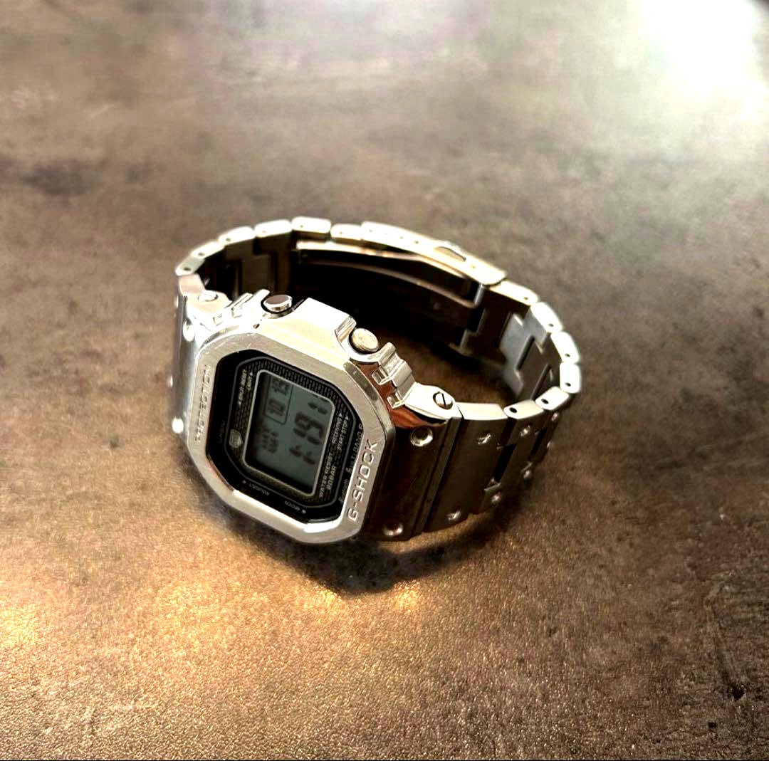 Casio G-Shock GMW-B5000D digital watch with stainless steel strap and classic square face