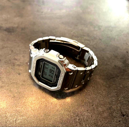 Casio G-Shock GMW-B5000D digital watch with stainless steel strap and classic square face