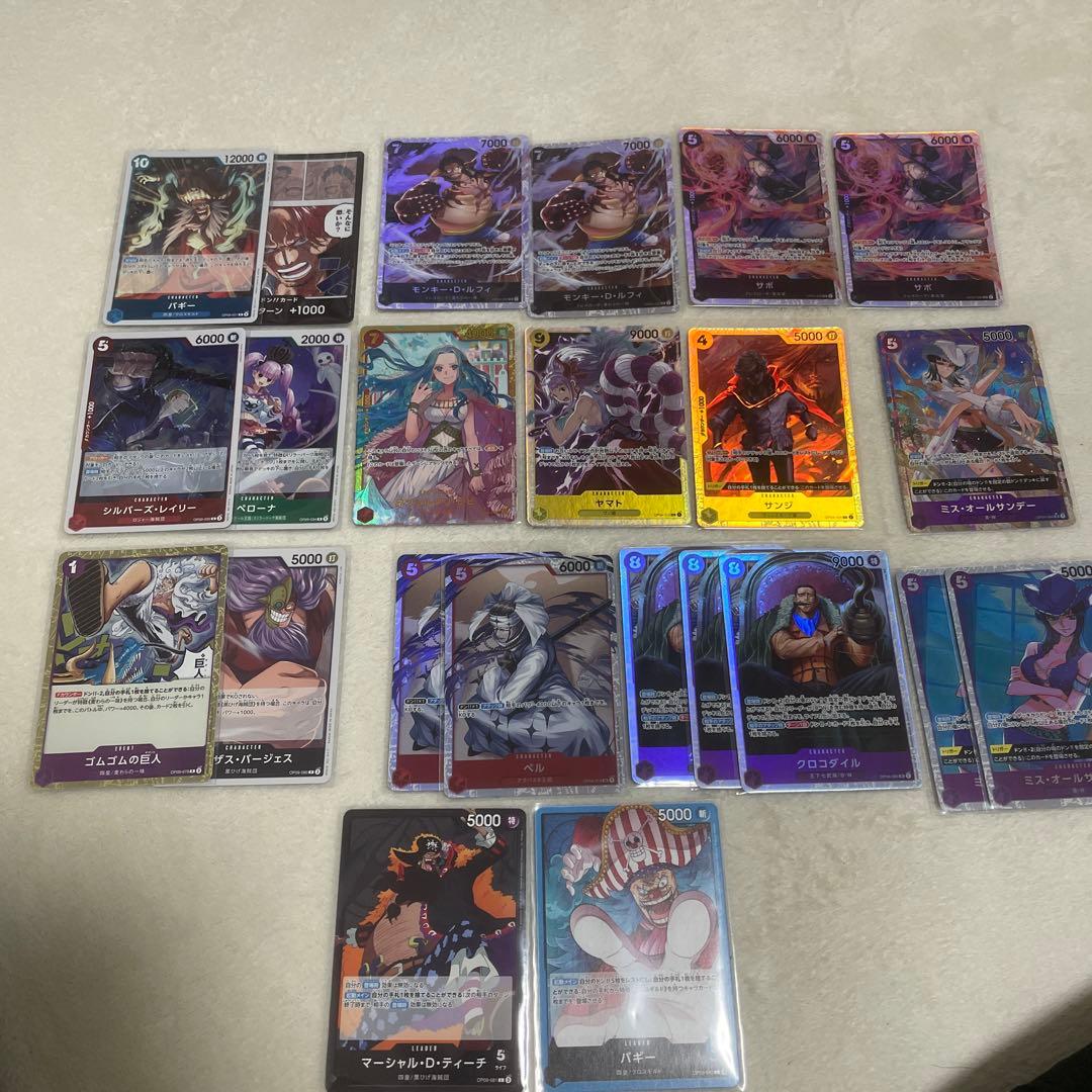 One Piece card set with Monkey D. Luffy SR, Sabo SR, Shanks R, and other rare cards in protective sleeves