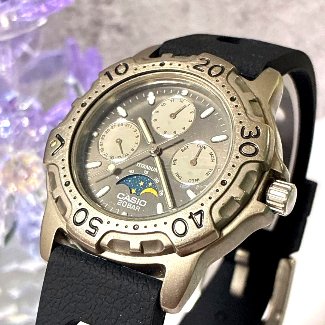 Casio MD-803 titanium diver watch with triple calendar and moonphase display on a black background