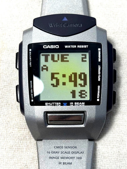 Casio Wrist Camera WQV-1 showing front view with functional buttons and visible scratches and marks