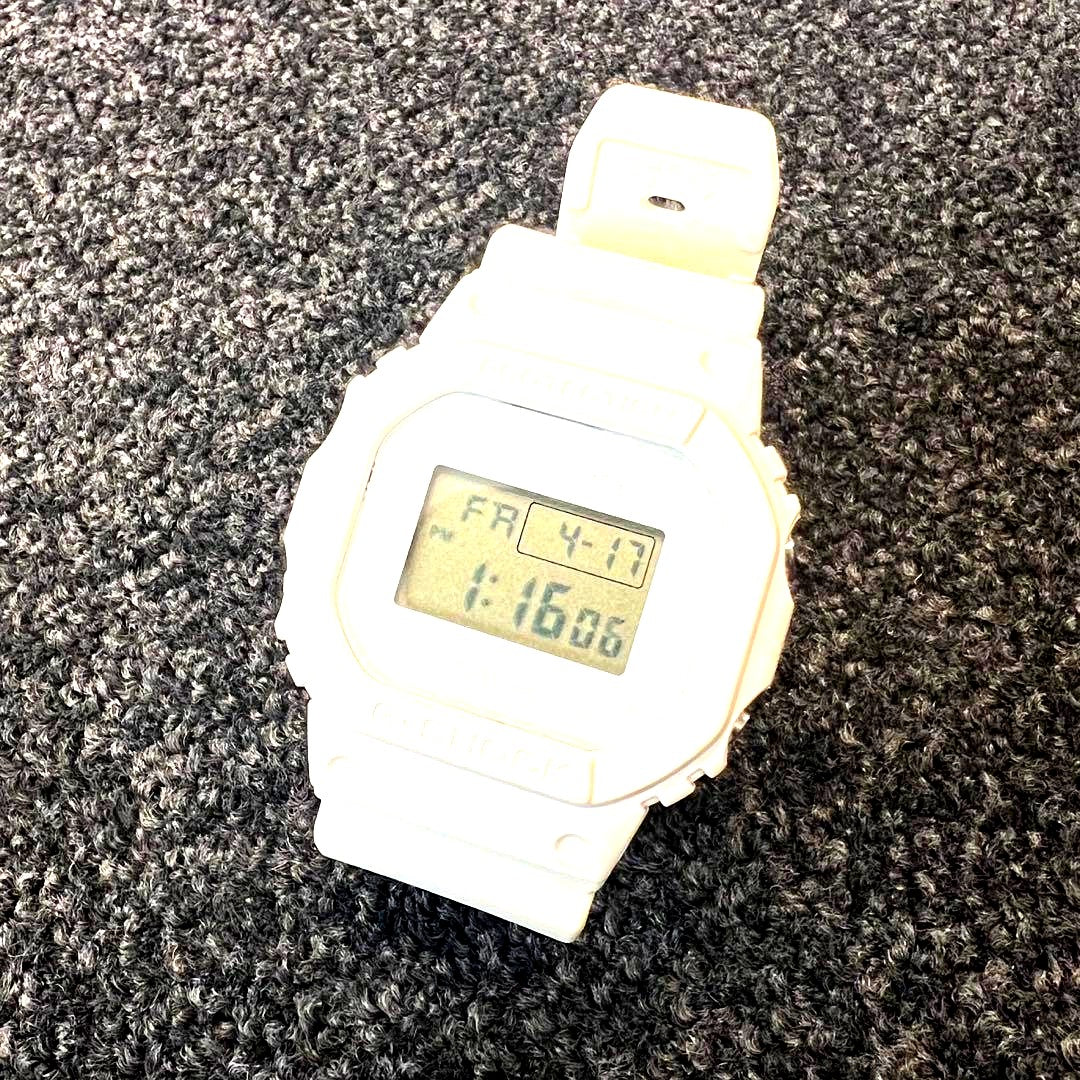 Casio G-Shock white digital watch collaboration with Kinashi Cycle showing front display and band